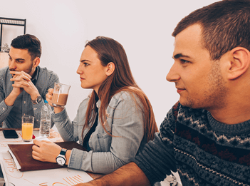 image depicting team members round a table